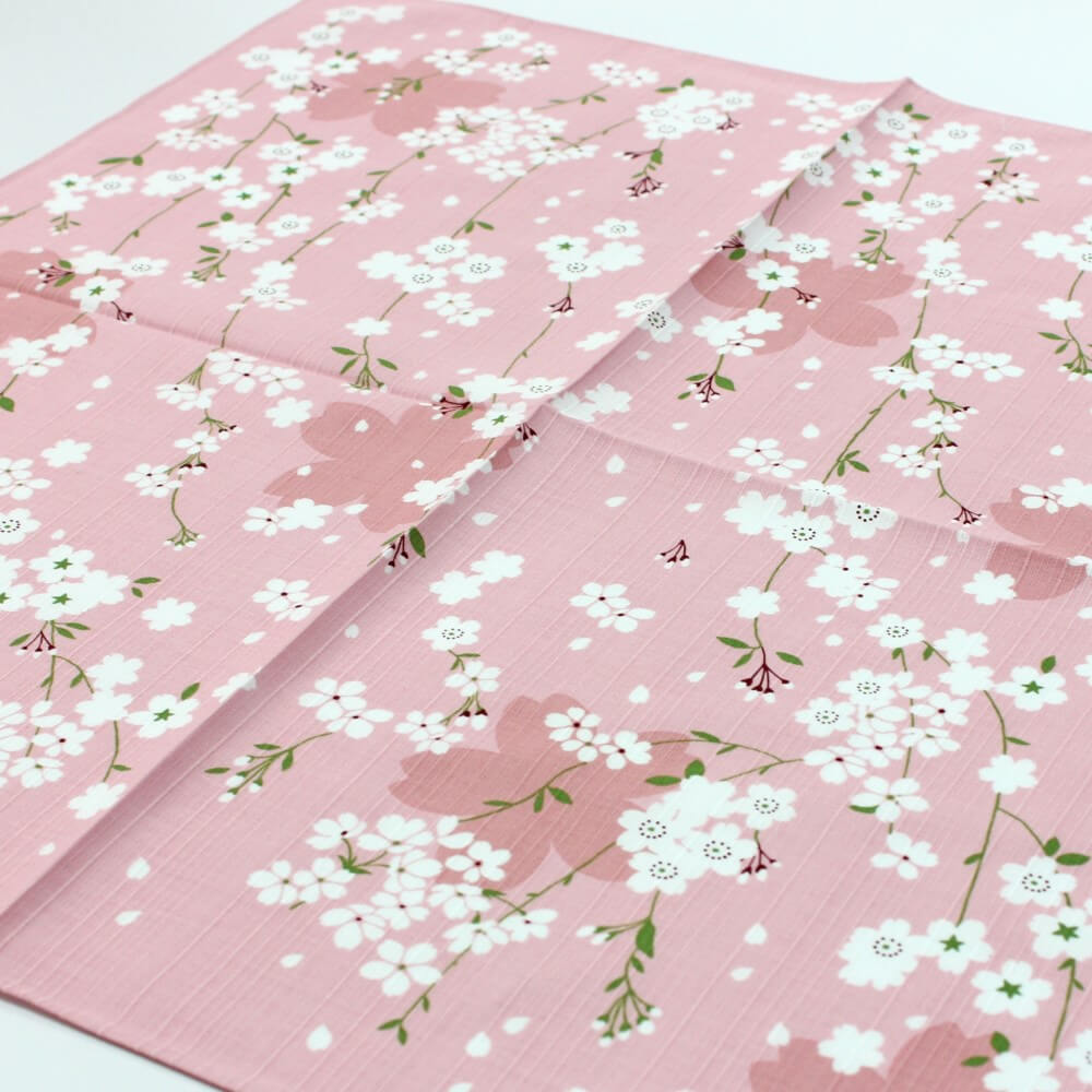 angled photo showing the sakura flowers on pink furoshiki