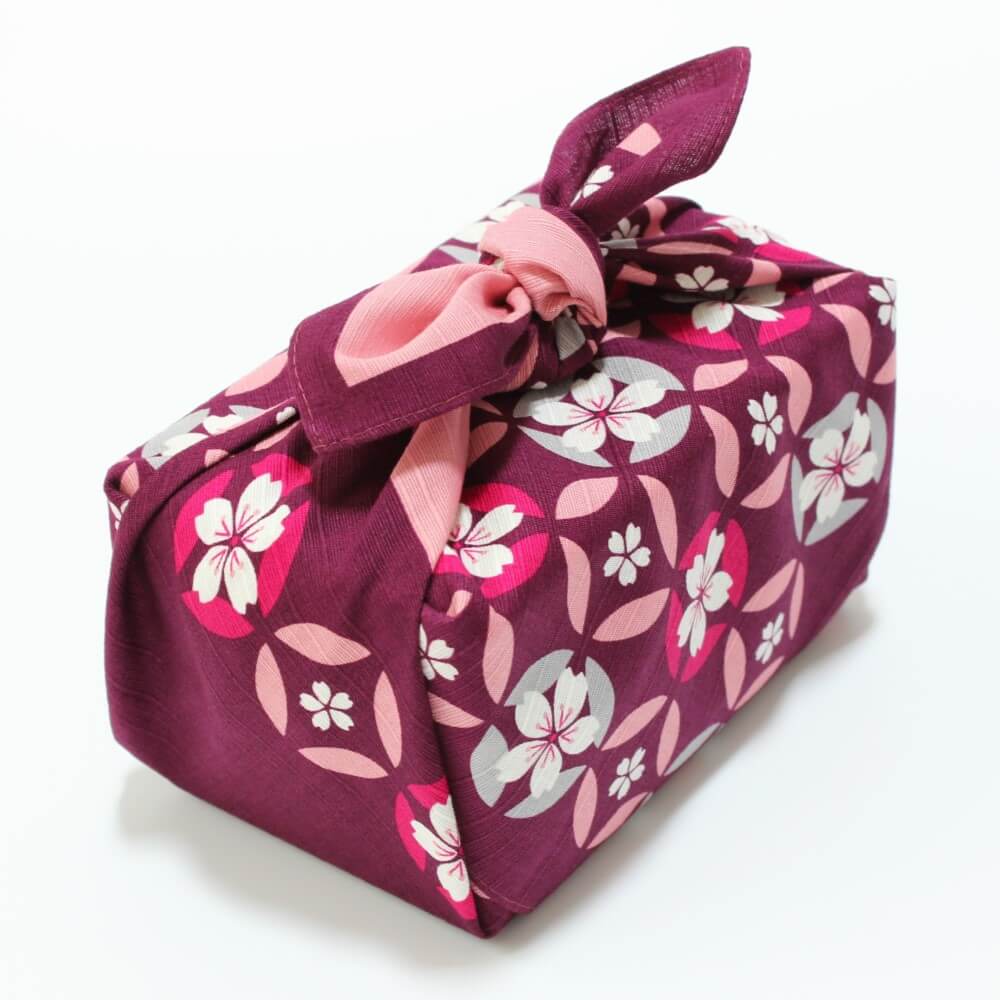 angled shot bento box wrapped with shippou zakura furoshiki