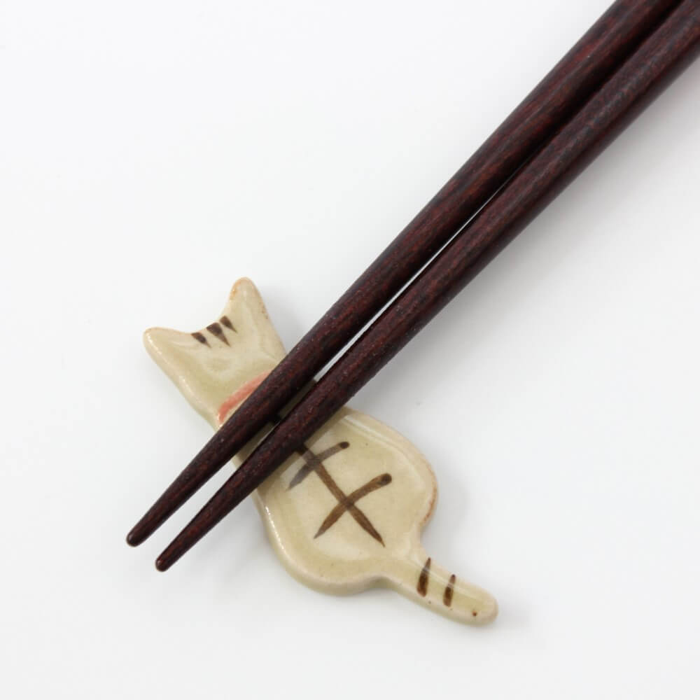 close up chopsticks tips on tabby cat rest