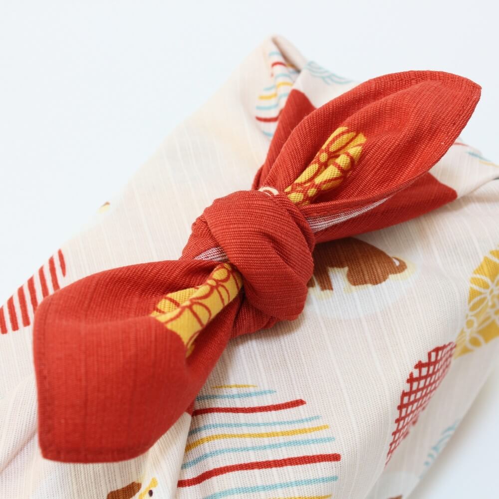 close up tied knot mame shiba komon red furoshiki