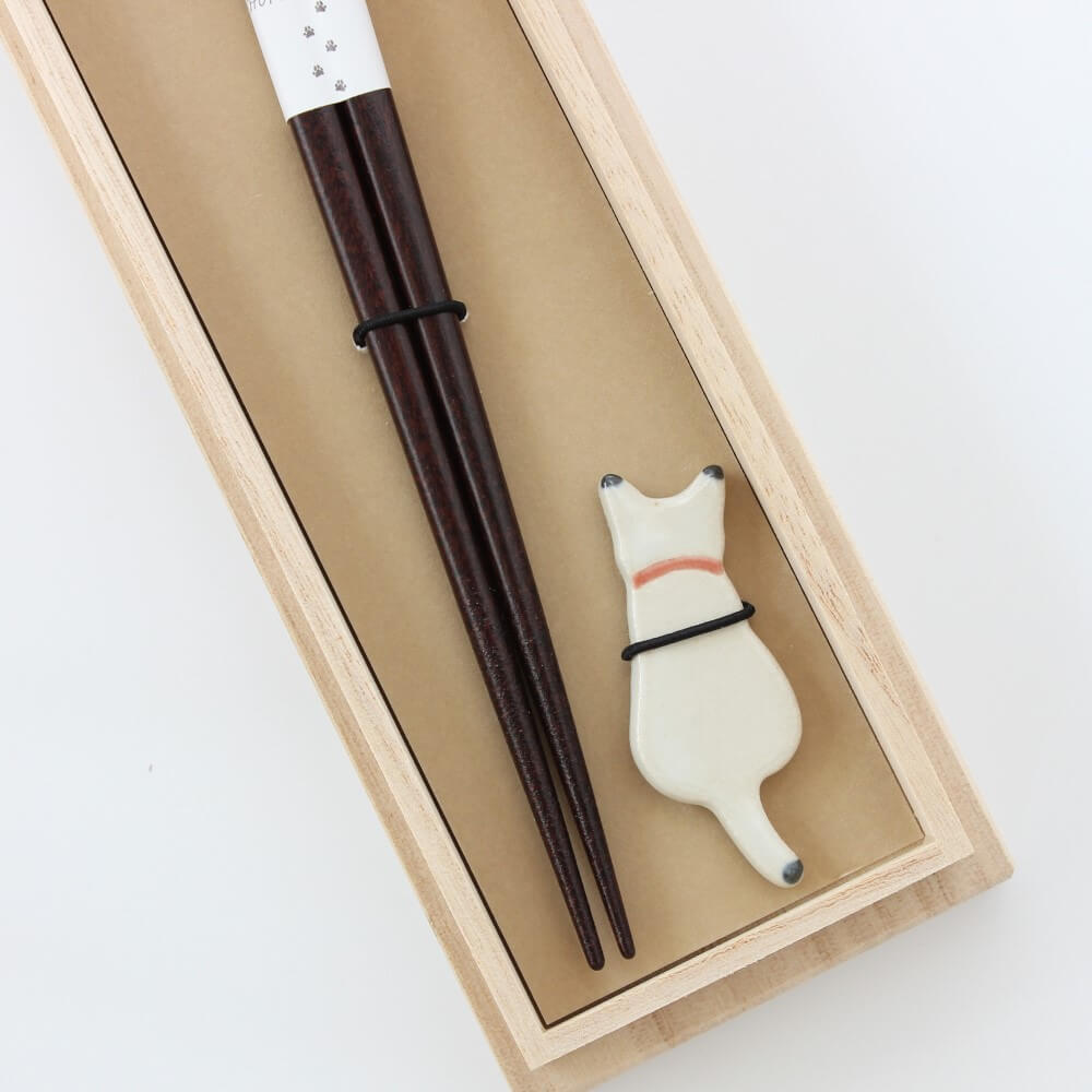 close up white cat chopsticks rest