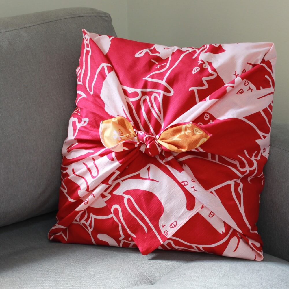 cushion wrapped with 105cm cat puzzle furoshiki on sofa