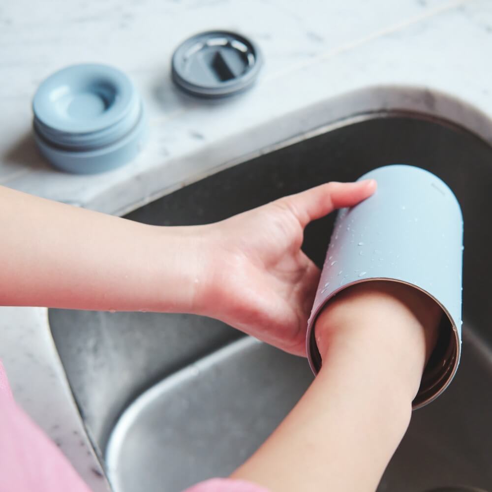 lantern bottle being washed with hand inside the bottle