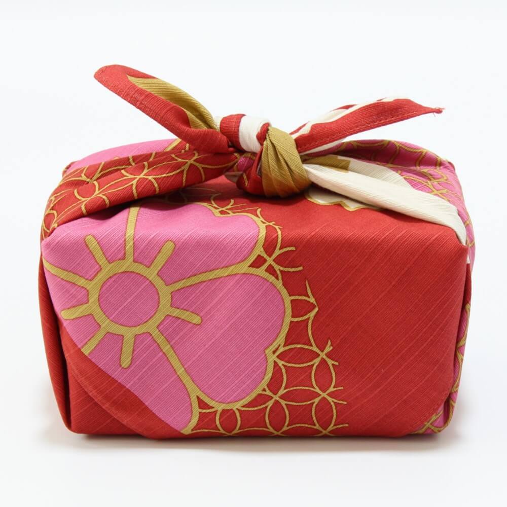 side profile bento box wrapped in sakura nishiki furoshiki