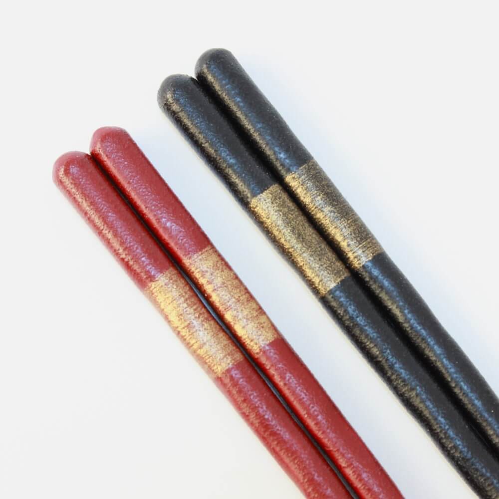 ultra close up red black nishiki goi chopsticks