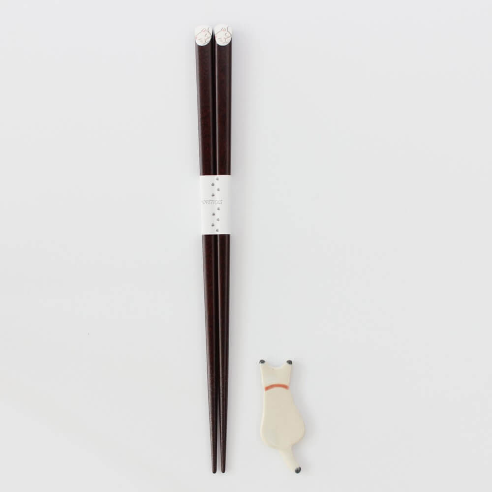 white cat chopsticks and rest